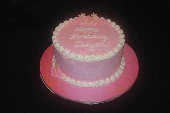 round pink birthday cake